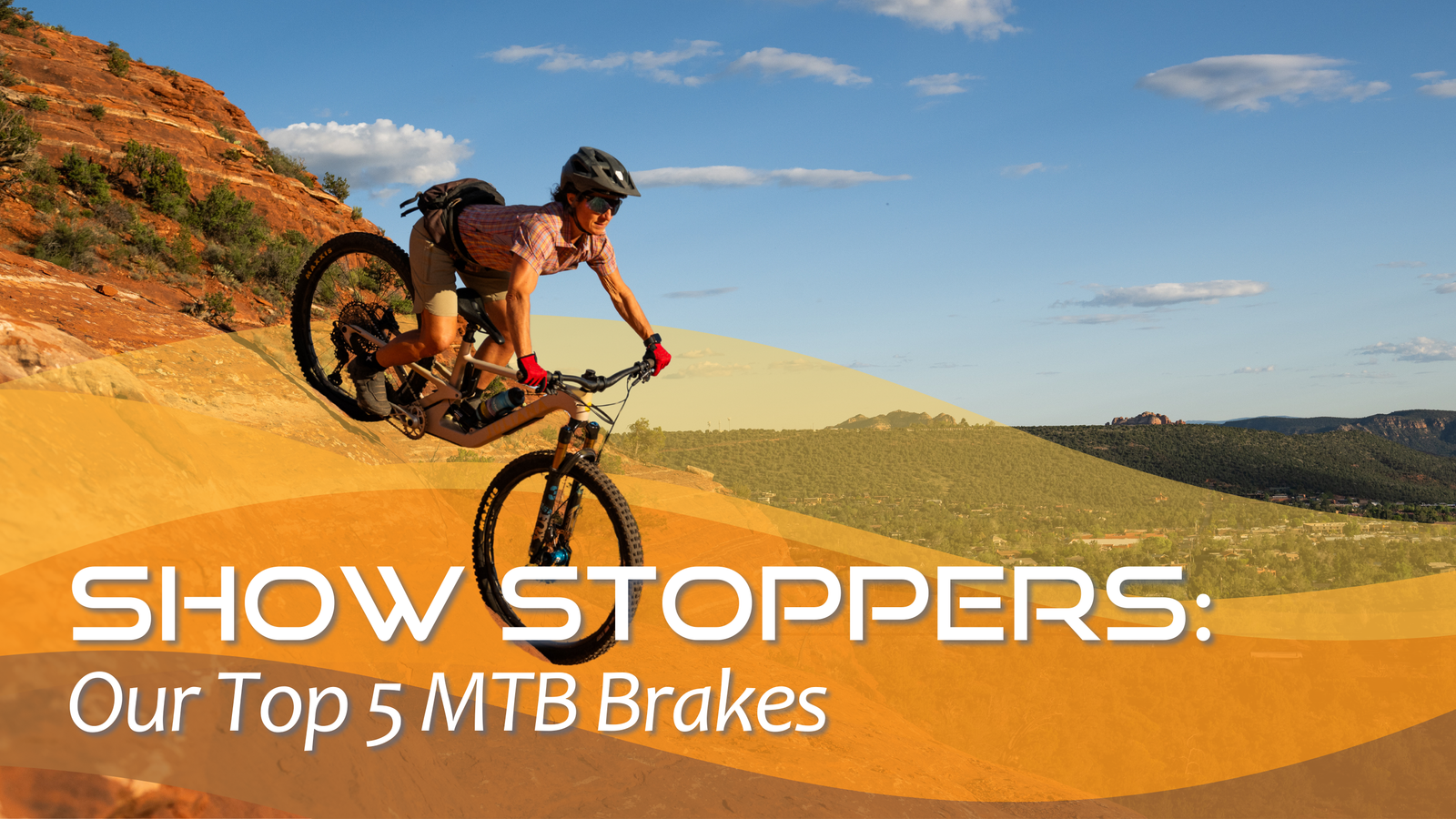 Rider on mountain bike navigating red rock trail, showcasing top MTB brakes for rugged terrain