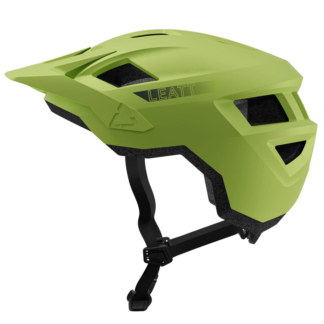 Green helmet with black straps on a white background