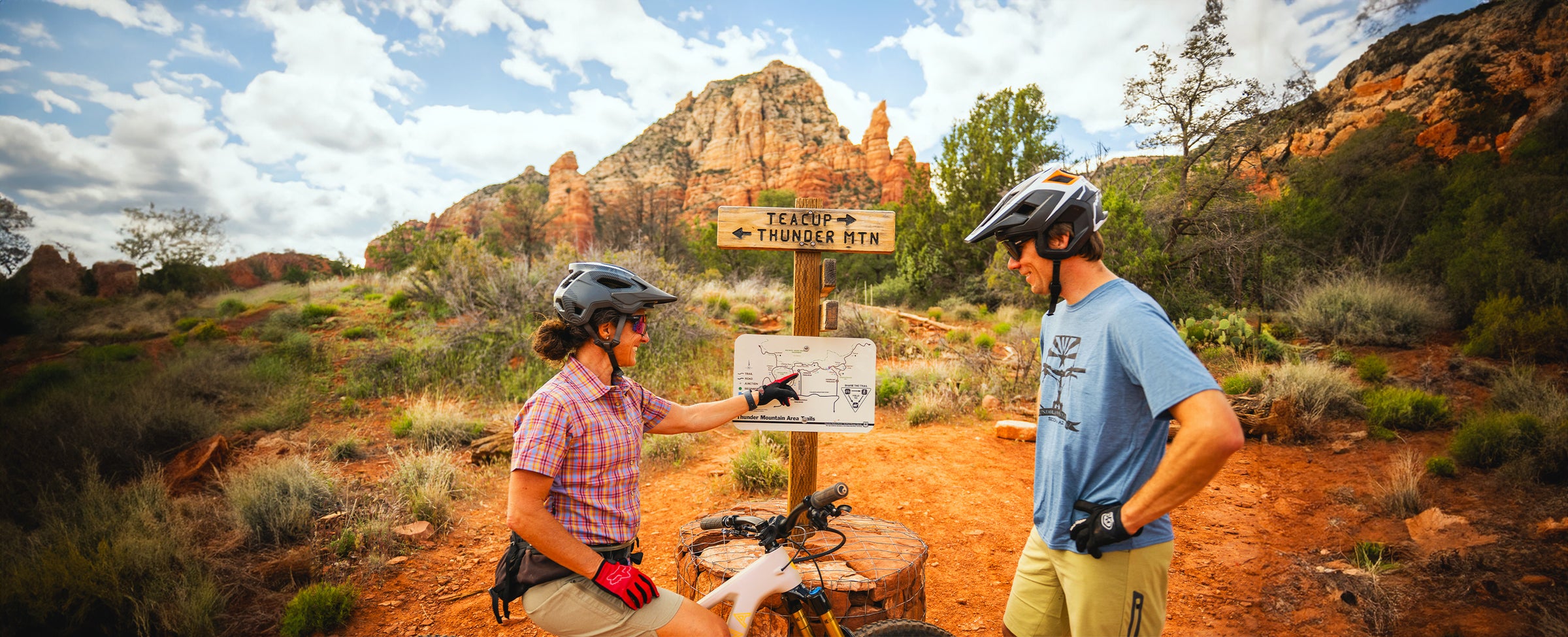 riders stopped at trail sign to plan bike route in Sedona Arizona